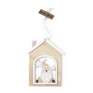 A wooden Christmas decoration shaped like a house, featuring a Santa figure and stars in white and natural wood tones.