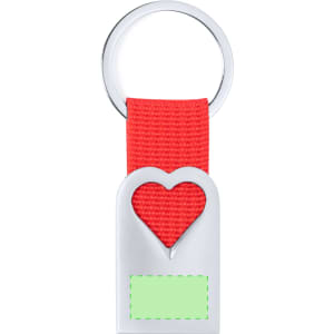 A red keyring with a heart-shaped cut-out and a silver metal base, featuring a blank green area.