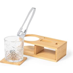 A glass tumbler with a diamond pattern rests on a wooden bamboo base. The set features a sleek, modern design.