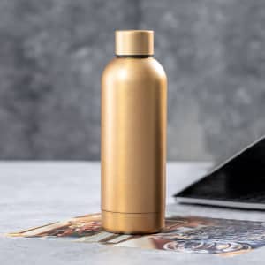 A drink bottle in a sleek gold finish with a rounded body and a secure screw-on lid. It features a logo.
