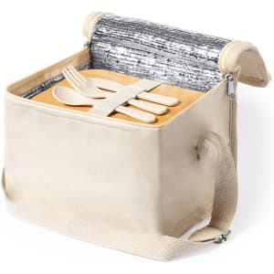 A cooler bag in beige with a silver insulated lining, containing wooden utensils and a cutting board.