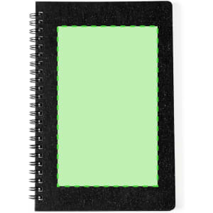 A black spiral notebook with a textured cover and a green blank area on the front. Branding is present.