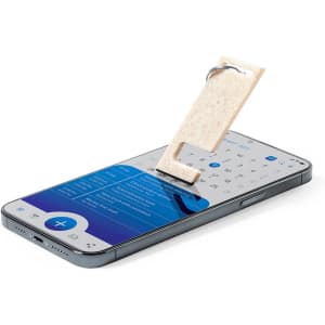 A multifunction keyring in a light colour, attached to a smartphone screen displaying a calendar interface.