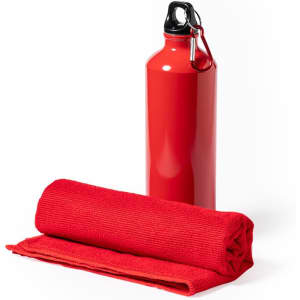 A red drink bottle with a black cap beside a rolled red towel. The bottle features a logo.