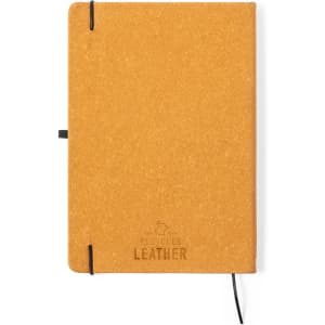 A mustard yellow notepad with a textured cover and elastic closure, featuring a logo on the front.
