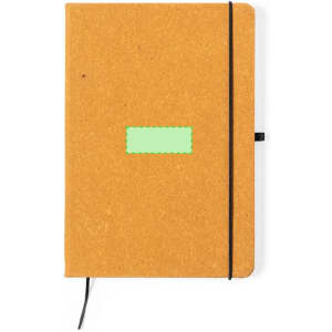 A brown notepad with a green label and a black elastic band closure, featuring a ribbon bookmark.