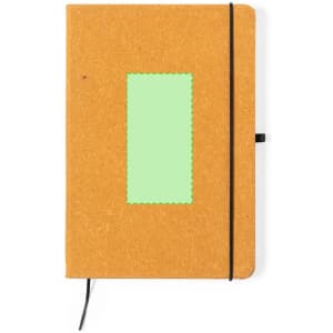 An orange notepad with a black elastic band and a green stitched label on the front.