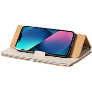 A cork notebook holder with a smartphone propped up, featuring a beige notebook and a sleek design.