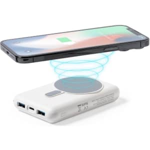 A white power bank with multiple USB ports, featuring a wireless charging area for smartphones above it.