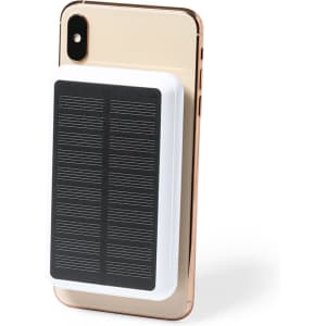 A power bank in white with a black solar panel design, mounted on a gold smartphone.