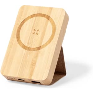 A bamboo power bank with a circular design and a built-in stand, featuring two ports for charging devices.