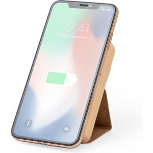 A smartphone with a wood-grain case, displaying a battery icon, resting on a stand. The screen shows a blurred background.