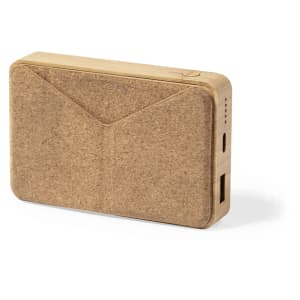 A power bank in natural brown colour with a textured surface and a logo. It features USB ports for charging devices.