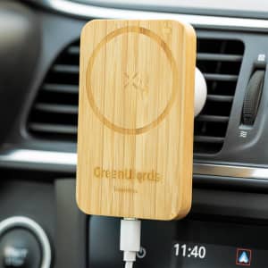 A bamboo wireless charger holder mounted in a car, featuring a circular charging area and a logo.