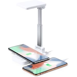A multifunction lamp in white, featuring a sleek design with a foldable arm and two charging phones.