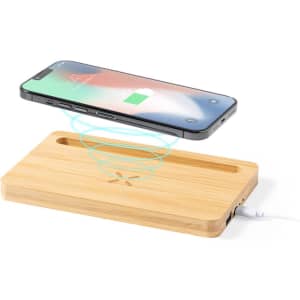 A wooden wireless charger with a smartphone positioned above it, displaying a charging icon. It has a sleek and modern design.