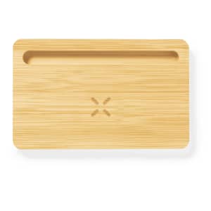 A bamboo charging organiser with a groove and a logo, designed for wireless charging devices.