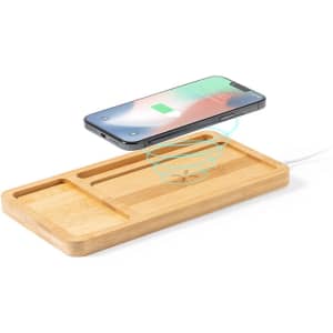 A bamboo wireless charger with a smartphone above it, featuring a sleek design and multiple compartments for organisation.