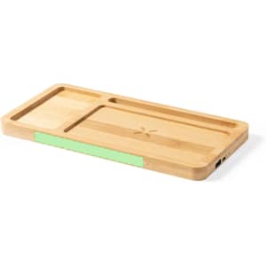 A wooden organiser with a light green accent, featuring compartments for tech accessories and wireless charging ports.