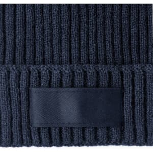 A navy blue beanie with a ribbed texture and a blank label patch.