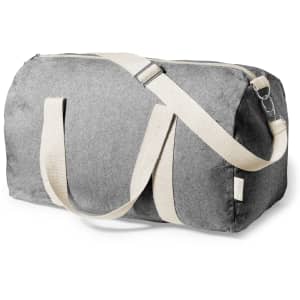 A grey bag with canvas straps and a zip closure, featuring a logo.