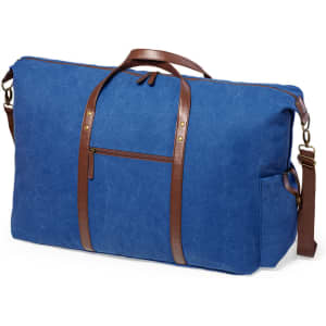 A blue tote bag with brown leather straps and a front pocket, featuring a branding logo.
