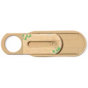 A beige webcam cover with a circular opening for attachment and a sliding mechanism to cover the lens.