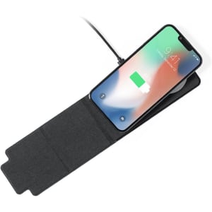 A black wireless charger with a smartphone on top, showing a charging indicator on the screen.