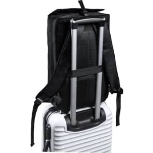 A black document bag backpack with adjustable straps attached to a wheeled suitcase handle.