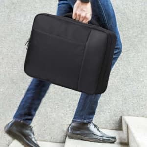 A black document bag backpack being carried by a person, featuring a sleek design and a logo.