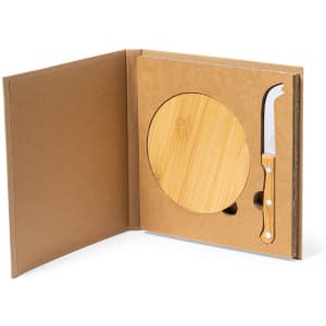 A cheese knife set with a bamboo cutting board and a white-handled knife, presented in a brown packaging.