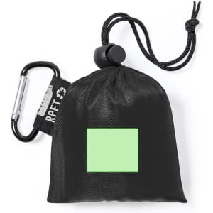 A compact black poncho packed in a pouch with a drawstring and carabiner, featuring a green square area.