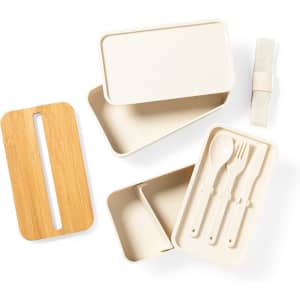 A light-coloured lunch box set with a bamboo lid, three utensils, and compartments for food storage.