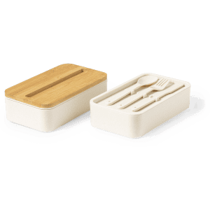 A beige lunch box with a bamboo lid and included utensils in a compartment. It features a simple, modern design.