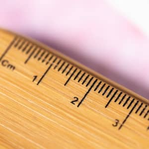 A bamboo ruler with clear measurement markings up to 30 centimetres, featuring a smooth finish.