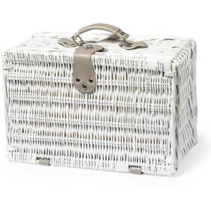 A white wicker picnic basket with a tan leather handle and closure. The basket has a structured shape and is stylishly designed.