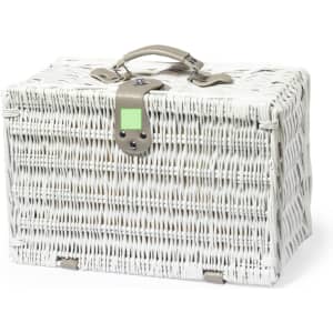 A white woven picnic basket with a leather handle and clasp, featuring a logo.