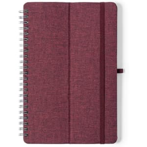 A maroon spiral-bound notebook with a textured cover and an elastic band. It features a branding logo.