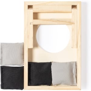 A wooden game set featuring a frame with a circular opening and four small fabric bags in grey and black.