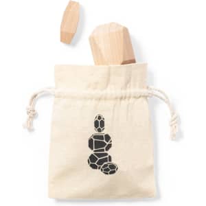 A natural canvas bag with a logo contains a wooden puzzle piece. One wooden piece is displayed beside the bag.
