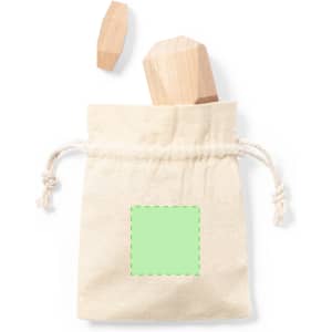 A natural fabric pouch containing wooden puzzle pieces, with one piece partially out of the bag.