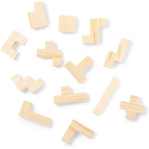 A collection of wooden puzzle pieces in various shapes arranged randomly. The pieces are light beige in colour.