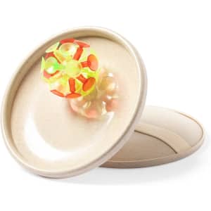 A beige game disc with a colourful, spiky ball on top. It has a logo and is designed for outdoor play.