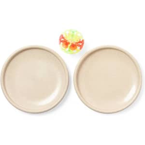 Two beige plates with a small multicoloured ball placed in between them. The plates have a smooth surface.