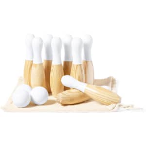 A set of wooden skittles with white tops, accompanied by three white balls, displayed on a light fabric surface.