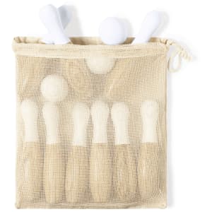 A mesh bag containing white skittle-shaped pieces, designed for the game "Spare Game Skittles."