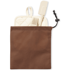 A brown storage pouch containing a cream spatula and a cream pot holder. The pouch has a drawstring closure and branding.
