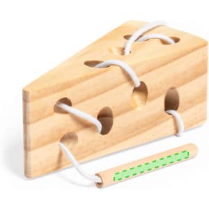 A wooden cheese-shaped skill game with several lacing holes and white string, featuring a green-threaded lacing tool.