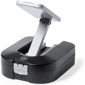 A black and silver tool set with a foldable design and a button on the front, featuring a compact case.