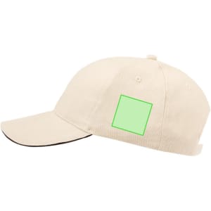 A cream cap featuring a green square on the side and a black trim along the visor.